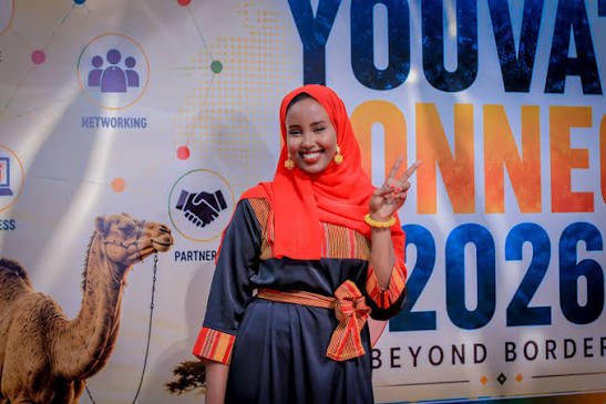 Participant in front of the YouVate Connect 2026 event backdrop